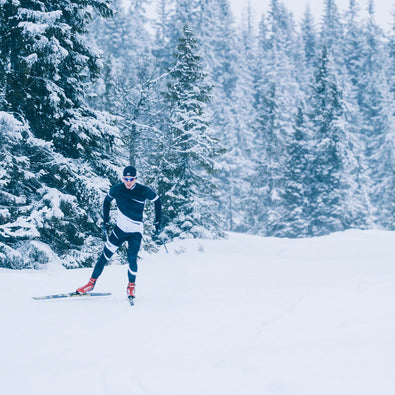 A man skiing in his custom made Ambition Racesuit from Trimtex