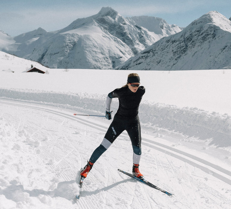 Woman skiing alone in the mountain wearing competition skiwear Vision shirt and tights from Trimtex