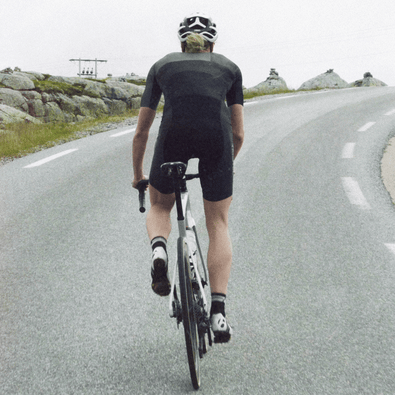 triathlete biking in full speed in her Trimtex Drive Speedsuit