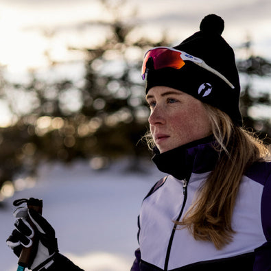 Skiier standing at ski tracks, wearing Trimtex Pulse skiing vest, Pulse jacket and Pulse beanie.
