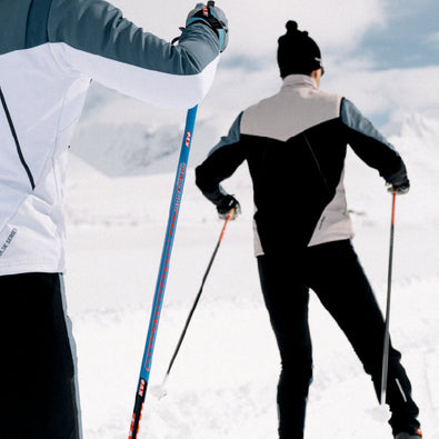 Back of a man skiing, you can see the black elastic panels of the Trimtex Pulse Vest, Jacket and Pants.