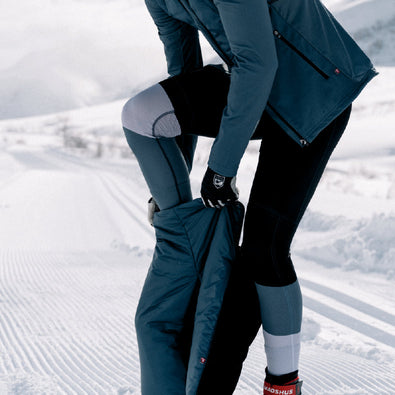 Skiier taking off her Trimtex Ace Primaloft Ski shorts zipping it down on each sides to easy take the shorts off.