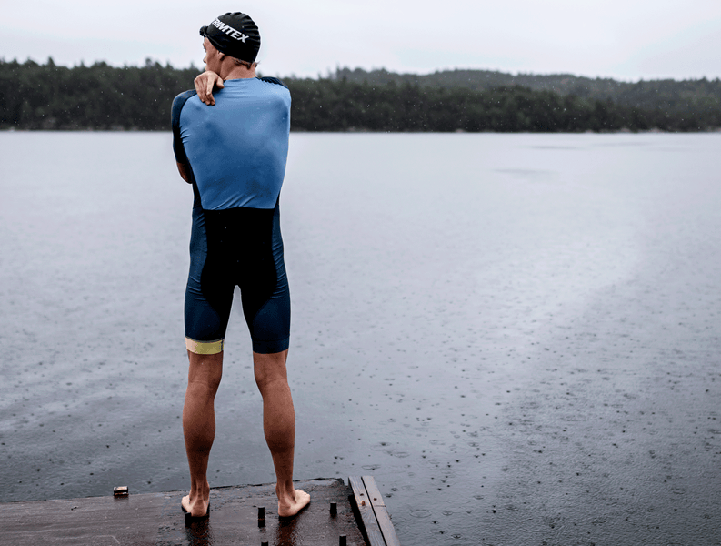 Triathlete ready to jump in the cold water in his Trimtex Drive Speedsuit